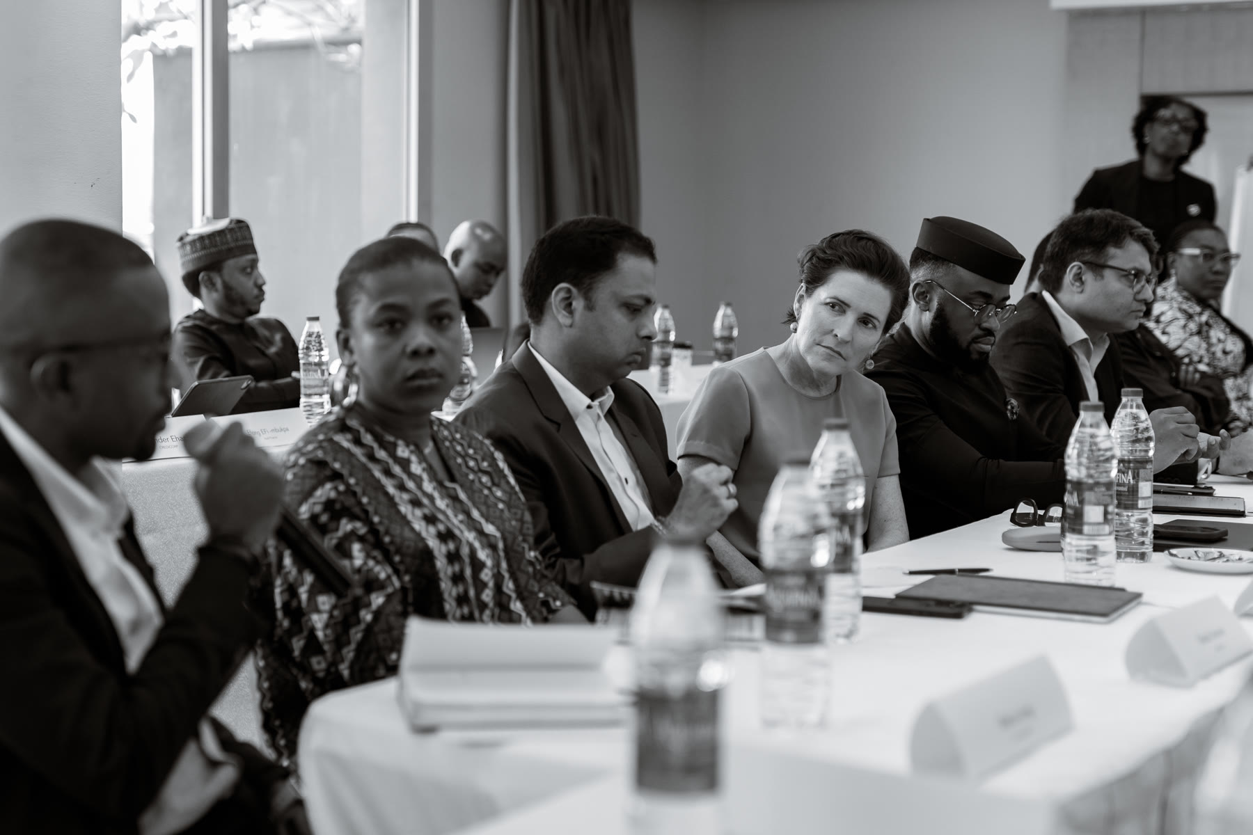A roundtable discussion photographed in black and white.
